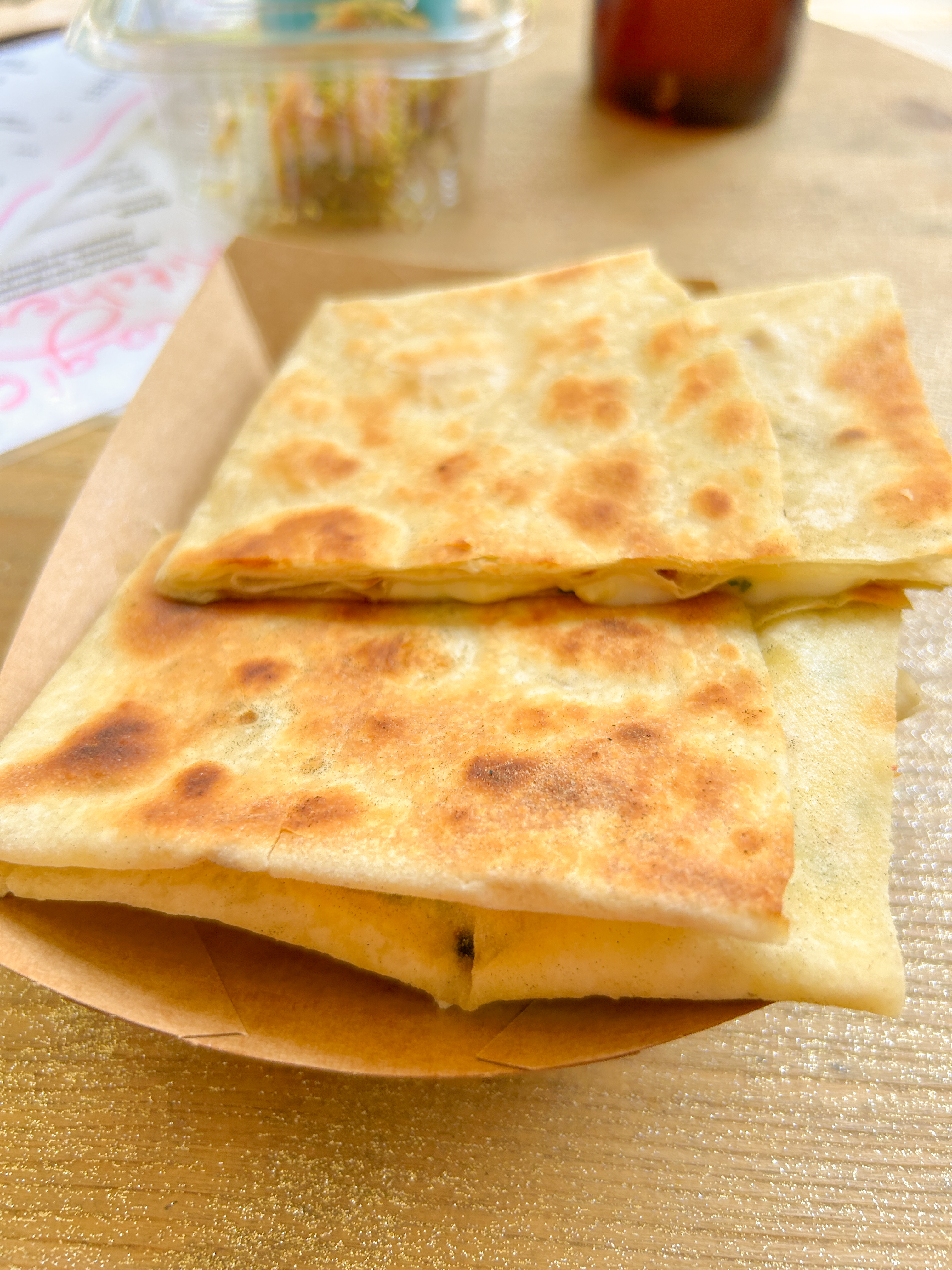 Flattened and folded tortilla that has been grilled.