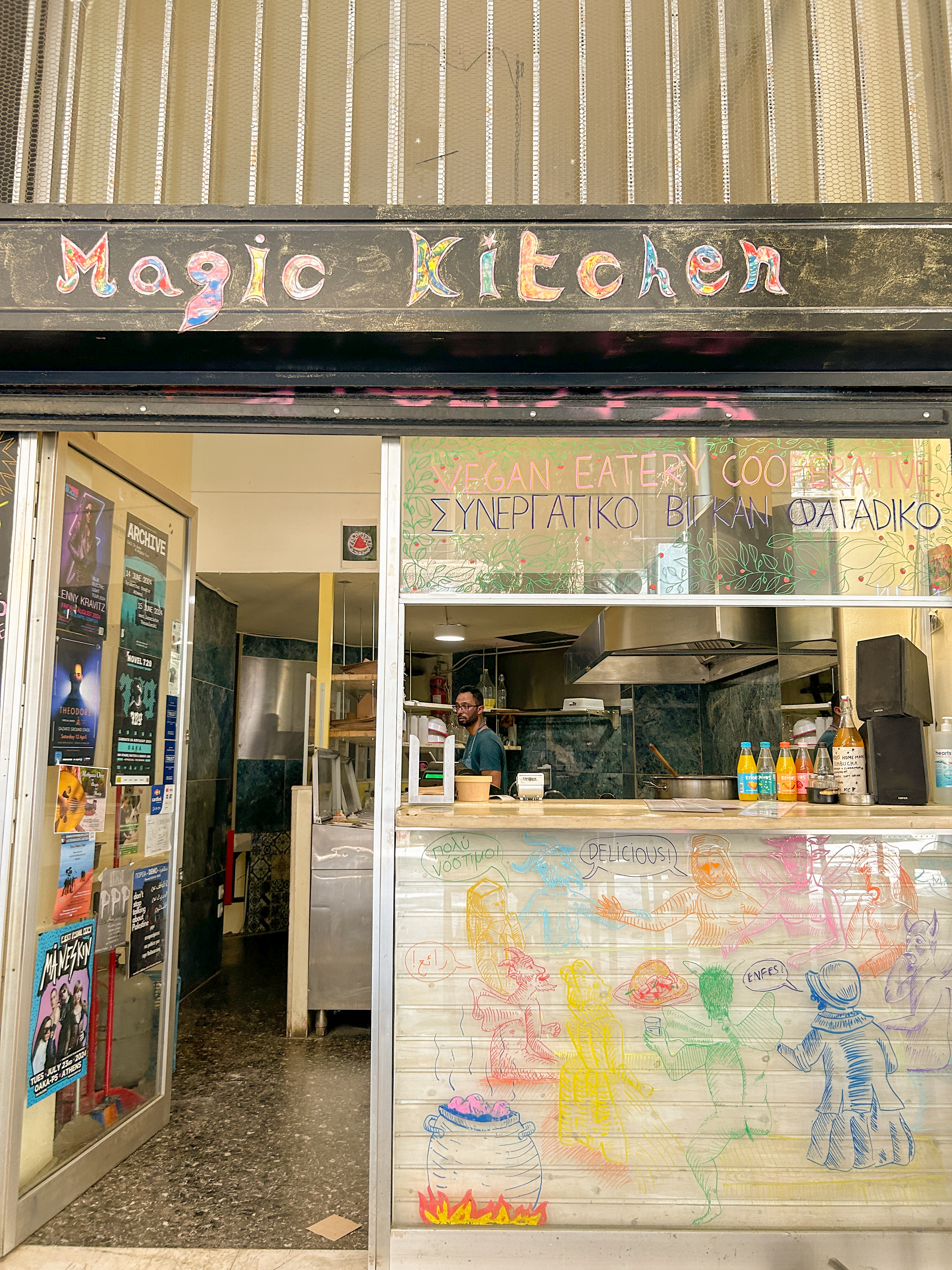 Exterior of restaurant featuring colorful paintings and the words 'Magic Kitchen'.