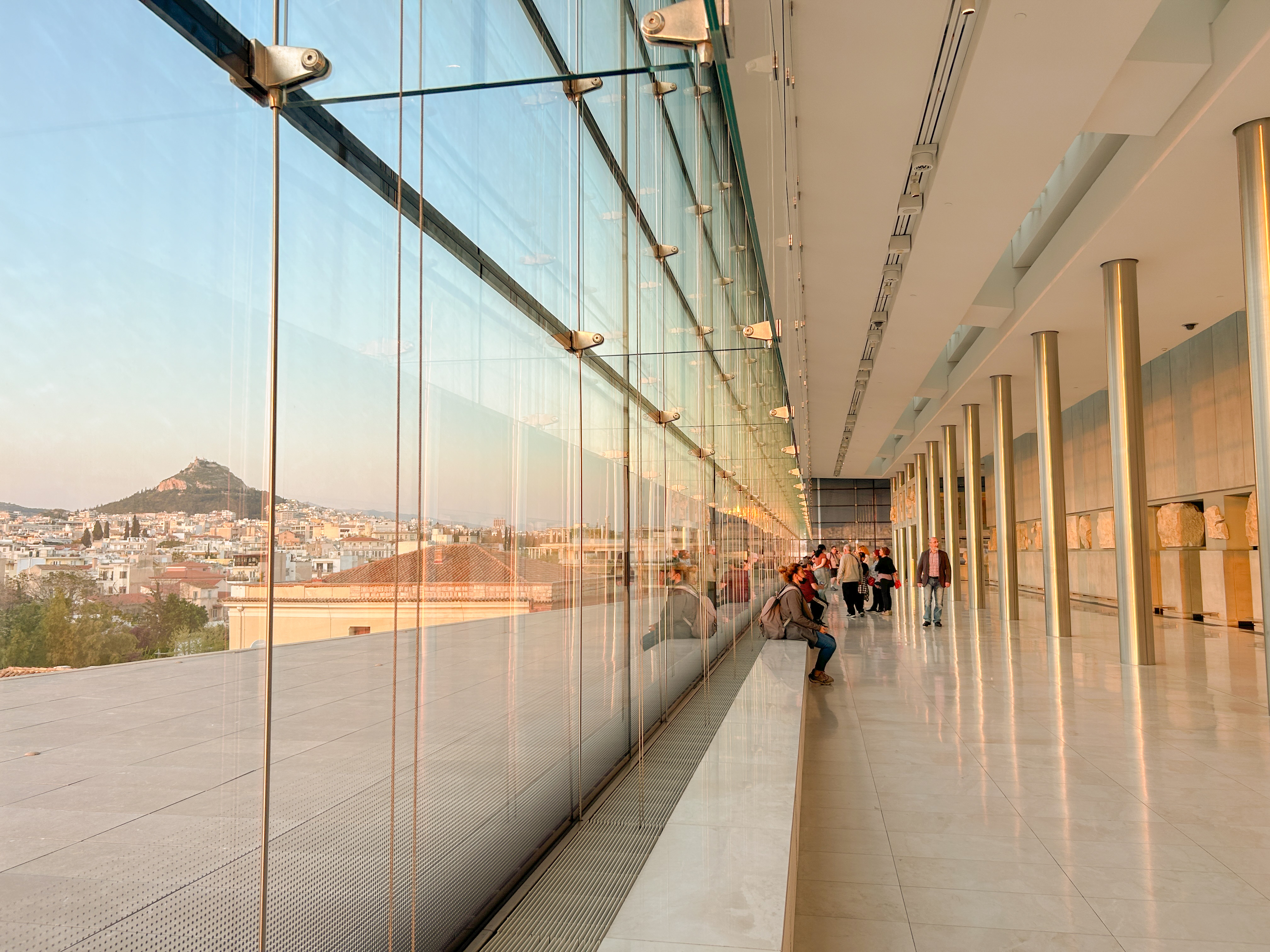 Museum room with floor to ceiling windows and silver poles.